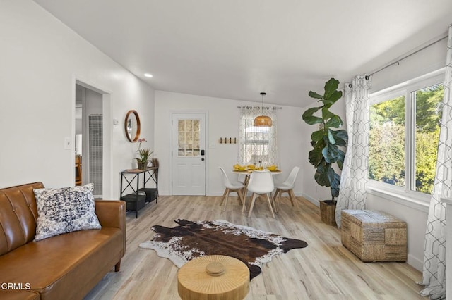 living room with vaulted ceiling and light hardwood / wood-style flooring