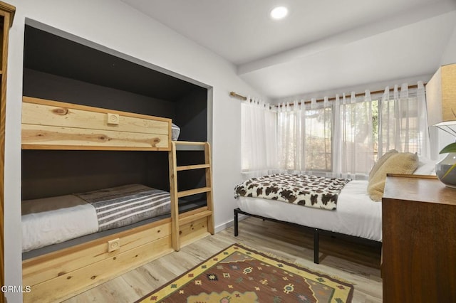 bedroom featuring hardwood / wood-style flooring and vaulted ceiling