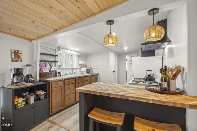 kitchen with wood ceiling, hanging light fixtures, lofted ceiling with beams, light hardwood / wood-style floors, and white fridge