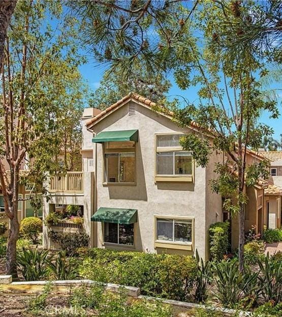 6 Daytona Dr Unit 128, Laguna Niguel, CA 92677 - rear view of house with stucco siding, a balcony, and a tile roof