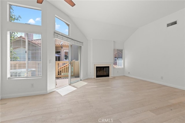 6 Daytona Dr Unit 128, Laguna Niguel, CA 92677 - unfurnished living room featuring vaulted ceiling, light wood-style flooring, healthy amount of natural light, a fireplace with flush hearth, and ceiling fan