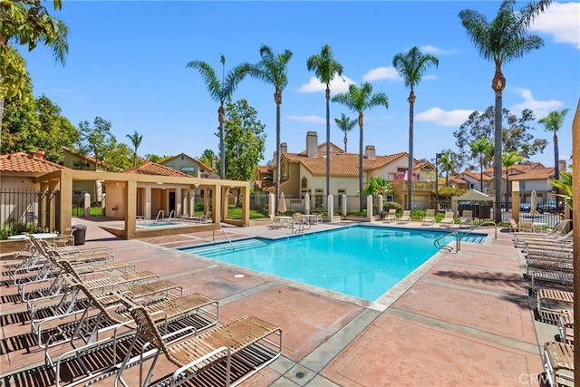 6 Daytona Dr Unit 128, Laguna Niguel, CA 92677 - community pool featuring a patio, a hot tub, and a residential view