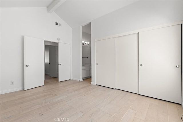 6 Daytona Dr Unit 128, Laguna Niguel, CA 92677 - unfurnished bedroom with beam ceiling, light wood-type flooring, a closet, high vaulted ceiling, and ensuite bathroom