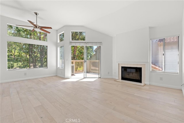 6 Daytona Dr Unit 128, Laguna Niguel, CA 92677 - unfurnished living room with a ceiling fan, a tile fireplace, light wood-style flooring, and lofted ceiling