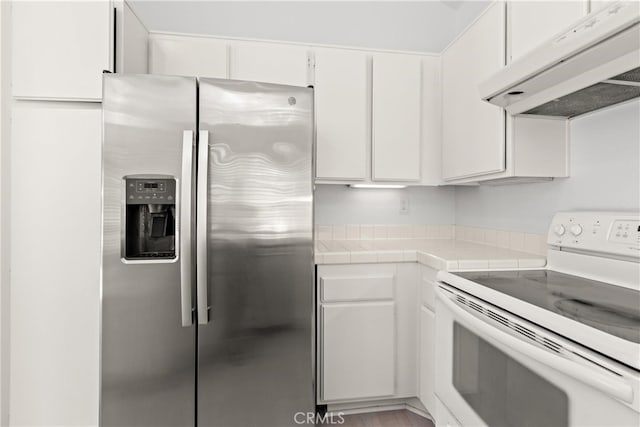 6 Daytona Dr Unit 128, Laguna Niguel, CA 92677 - kitchen with stainless steel refrigerator with ice dispenser, electric stove, under cabinet range hood, tile countertops, and white cabinets