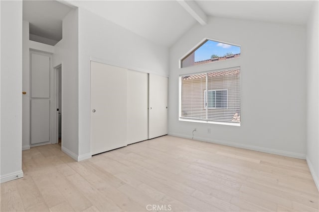 6 Daytona Dr Unit 128, Laguna Niguel, CA 92677 - unfurnished bedroom with beam ceiling, wood finished floors, a closet, and high vaulted ceiling