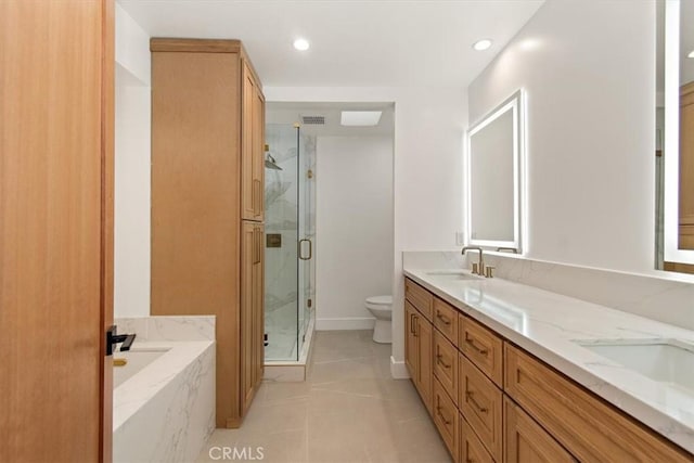 full bathroom with a marble finish shower, toilet, a garden tub, double vanity, and a sink