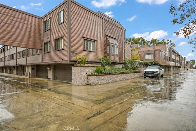 view of property featuring driveway and an attached garage