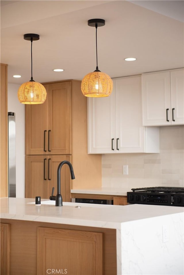 kitchen with decorative light fixtures, backsplash, recessed lighting, and white cabinetry