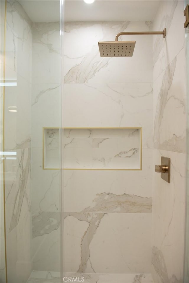 bathroom with a marble finish shower