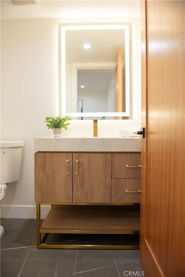 bathroom with tile patterned flooring, visible vents, toilet, and vanity