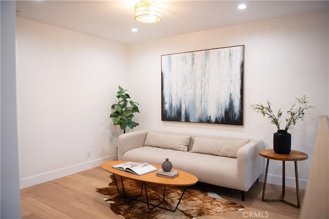 living area featuring recessed lighting, baseboards, and wood finished floors