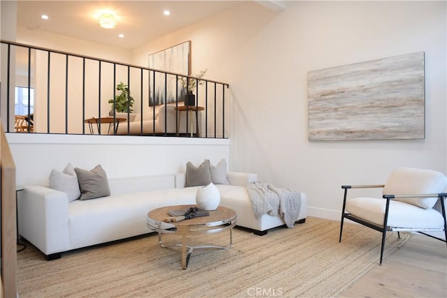 living area featuring recessed lighting, baseboards, and wood finished floors