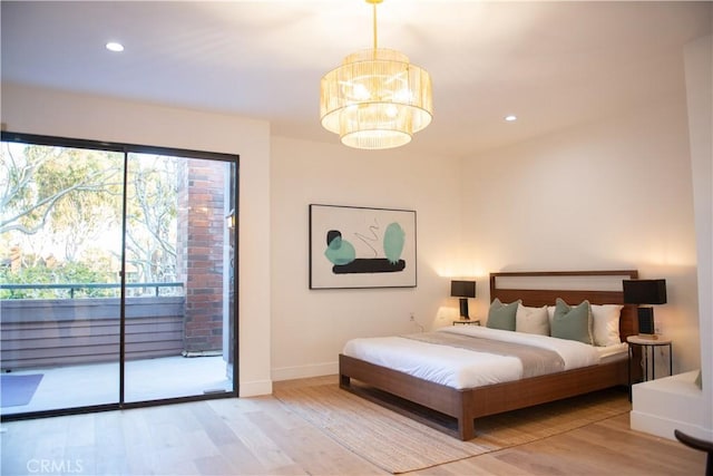 bedroom featuring recessed lighting, an inviting chandelier, light wood finished floors, baseboards, and access to exterior