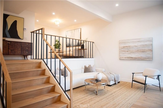 staircase featuring beamed ceiling, recessed lighting, baseboards, and wood finished floors