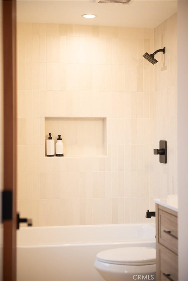 bathroom featuring vanity, toilet, and shower / bath combination