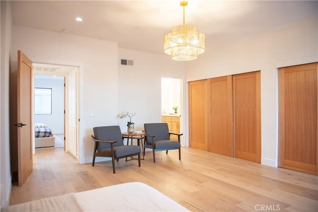 sitting room with recessed lighting, visible vents, light wood-style flooring, and a chandelier