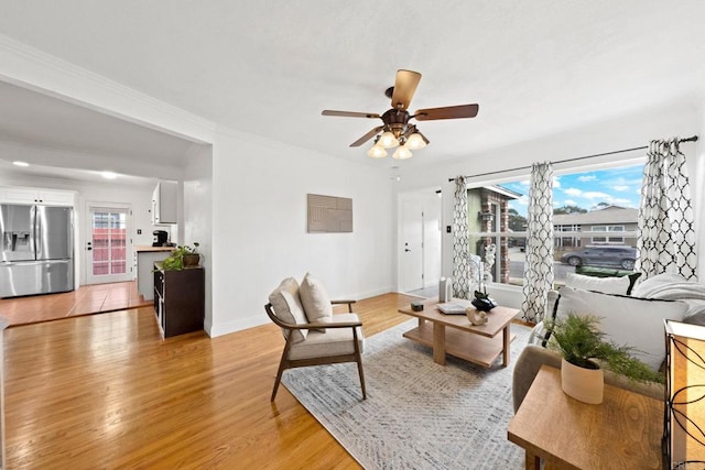 living room with ceiling fan and light wood-type flooring