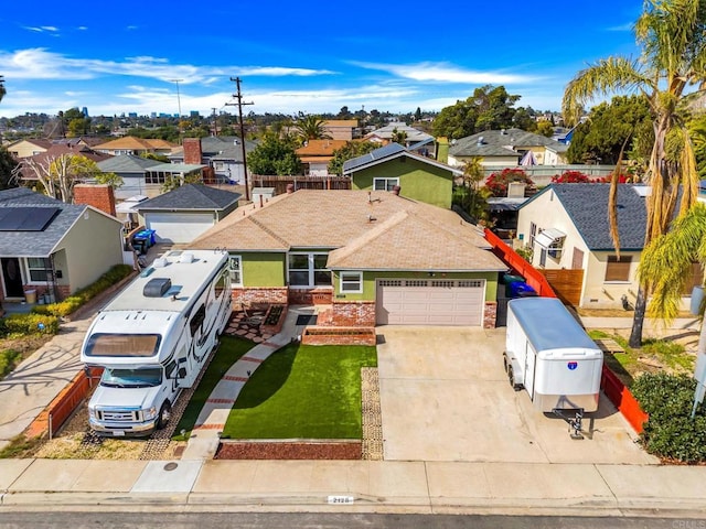 view of front of home featuring a garage and a front lawn