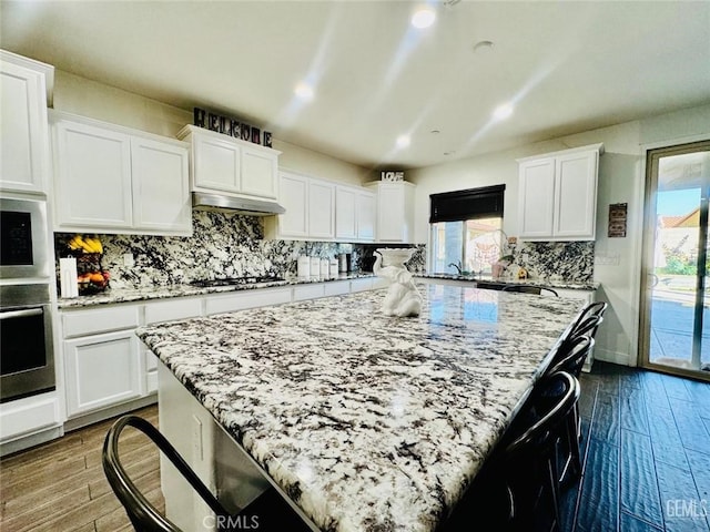 826 Jacob Creek Dr, Bakersfield, CA 93314 - kitchen featuring white cabinetry, stainless steel appliances, dark wood-type flooring, and a kitchen island