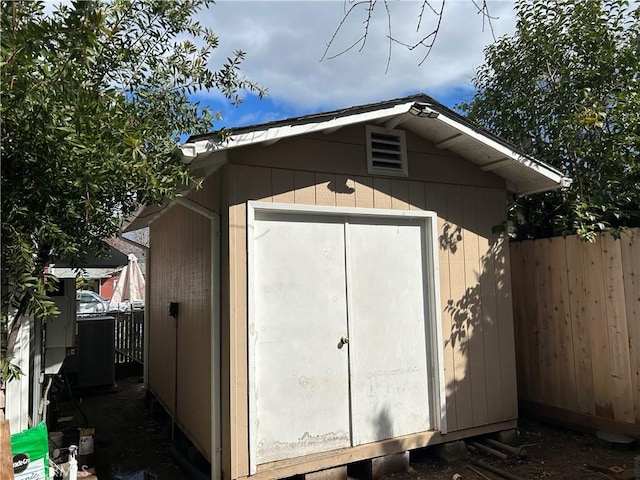 view of shed featuring fence