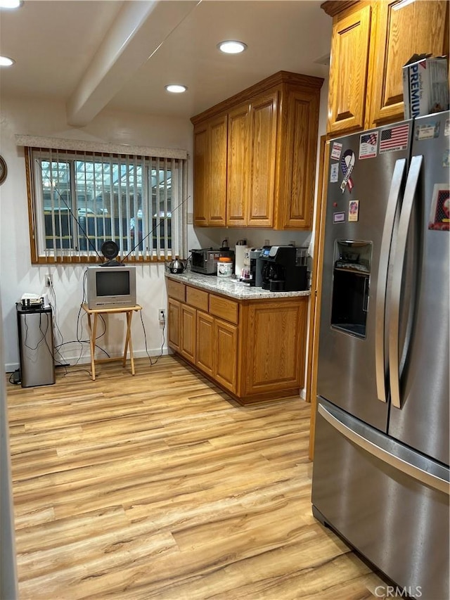 kitchen with recessed lighting, brown cabinets, stainless steel fridge with ice dispenser, and light wood finished floors