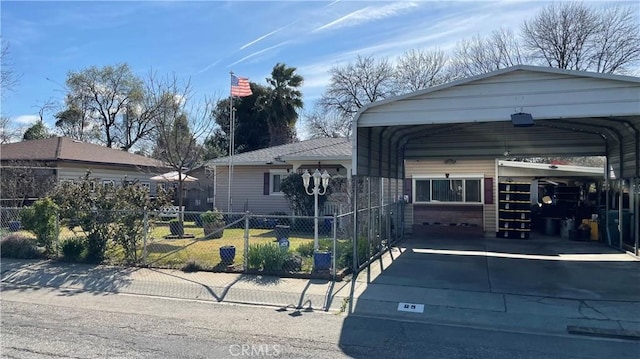 view of front of home with a carport, driveway, and fence
