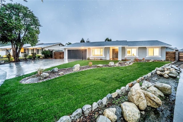 single story home with a front lawn and a garage