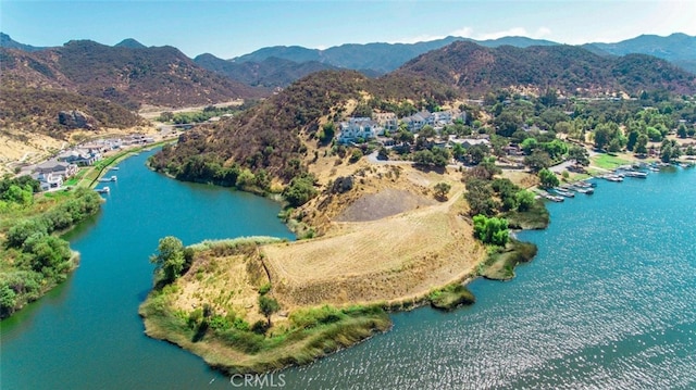 drone / aerial view with a water and mountain view