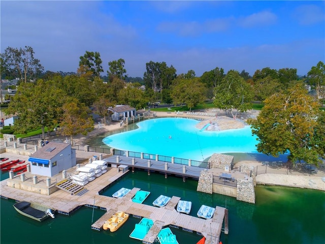 view of pool with a water view and a floating dock