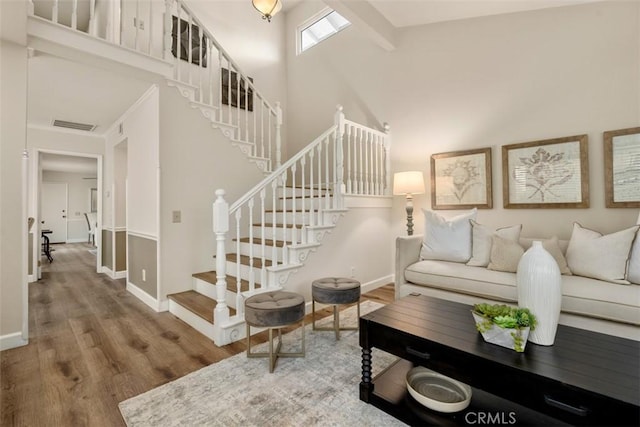 16 Wayfarer, Irvine, CA 92614 - living room with wood finished floors, a high ceiling, baseboards, and stairway