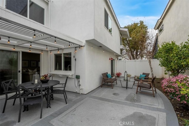 view of patio with fence, a pergola, and outdoor dining area