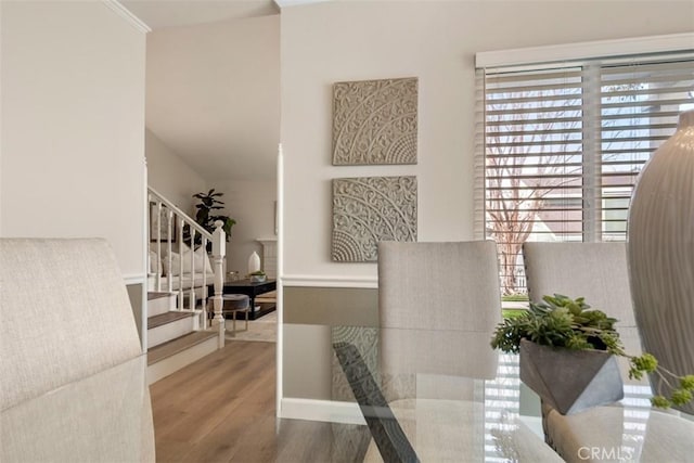 dining area featuring stairs and wood finished floors