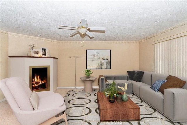 living room with ceiling fan and a textured ceiling