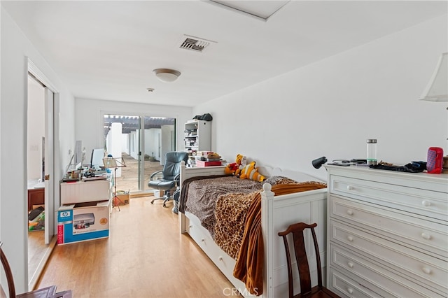 bedroom featuring access to outside and light hardwood / wood-style flooring