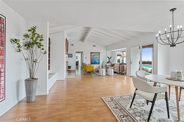 interior space featuring lofted ceiling with beams, a chandelier, and light hardwood / wood-style floors