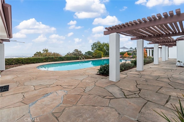 view of pool featuring a pergola, a patio, and a water view