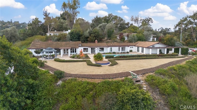 back of property featuring a gazebo