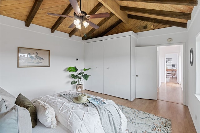 bedroom with wood ceiling, light hardwood / wood-style flooring, ceiling fan, lofted ceiling with beams, and a closet