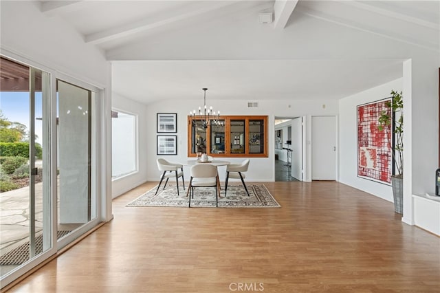 dining area with vaulted ceiling with beams, hardwood / wood-style floors, and a notable chandelier