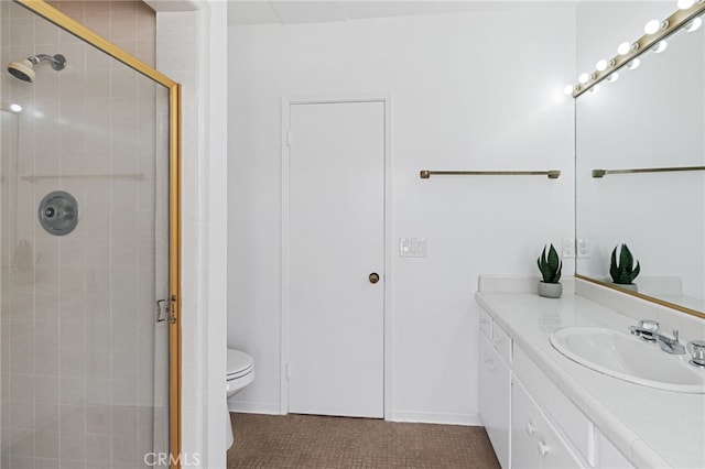 bathroom with walk in shower, vanity, and toilet
