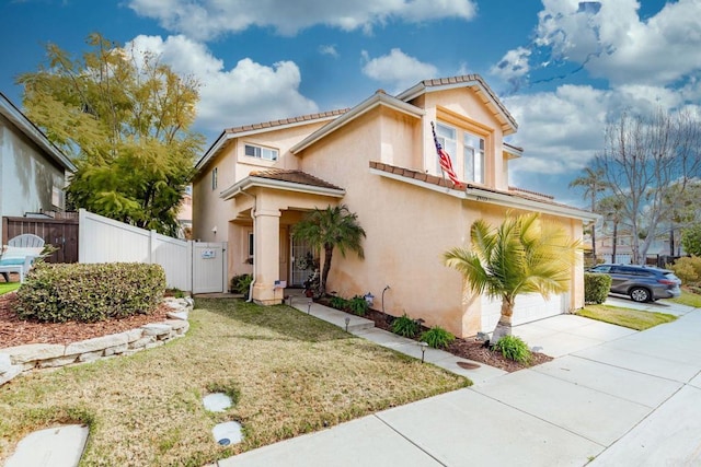 mediterranean / spanish-style house featuring a garage and a front yard