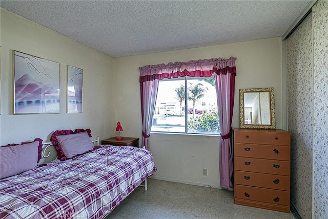 carpeted bedroom featuring a textured ceiling