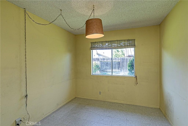 empty room with a textured ceiling