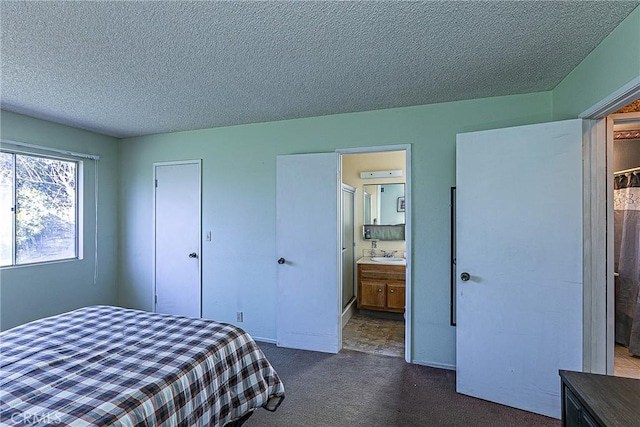 carpeted bedroom with sink, a textured ceiling, and a closet