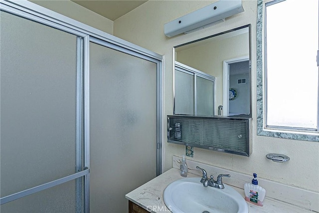 bathroom with vanity and an enclosed shower