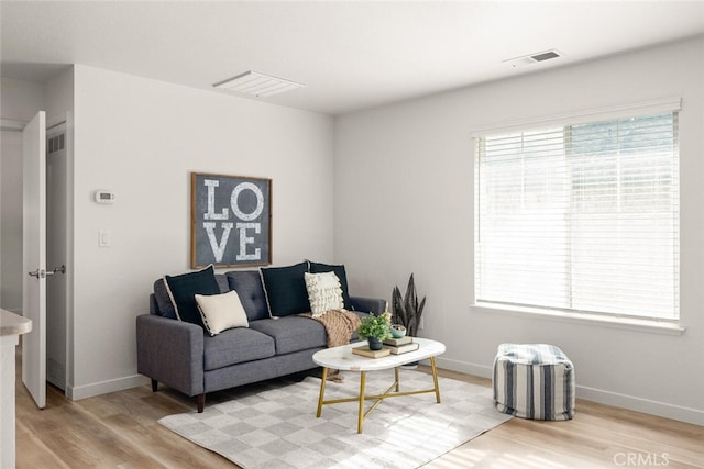 living room featuring plenty of natural light and light wood-type flooring