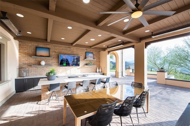 view of patio featuring an outdoor bar and ceiling fan