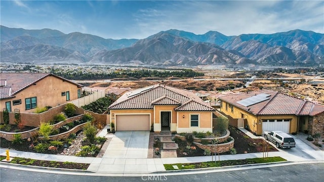 view of front facade with a garage and a mountain view