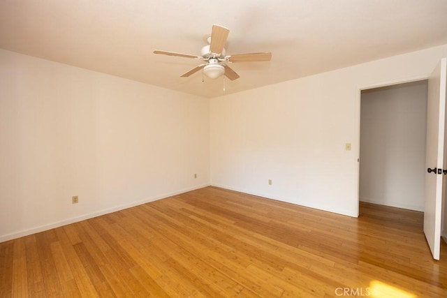 empty room with hardwood / wood-style flooring and ceiling fan